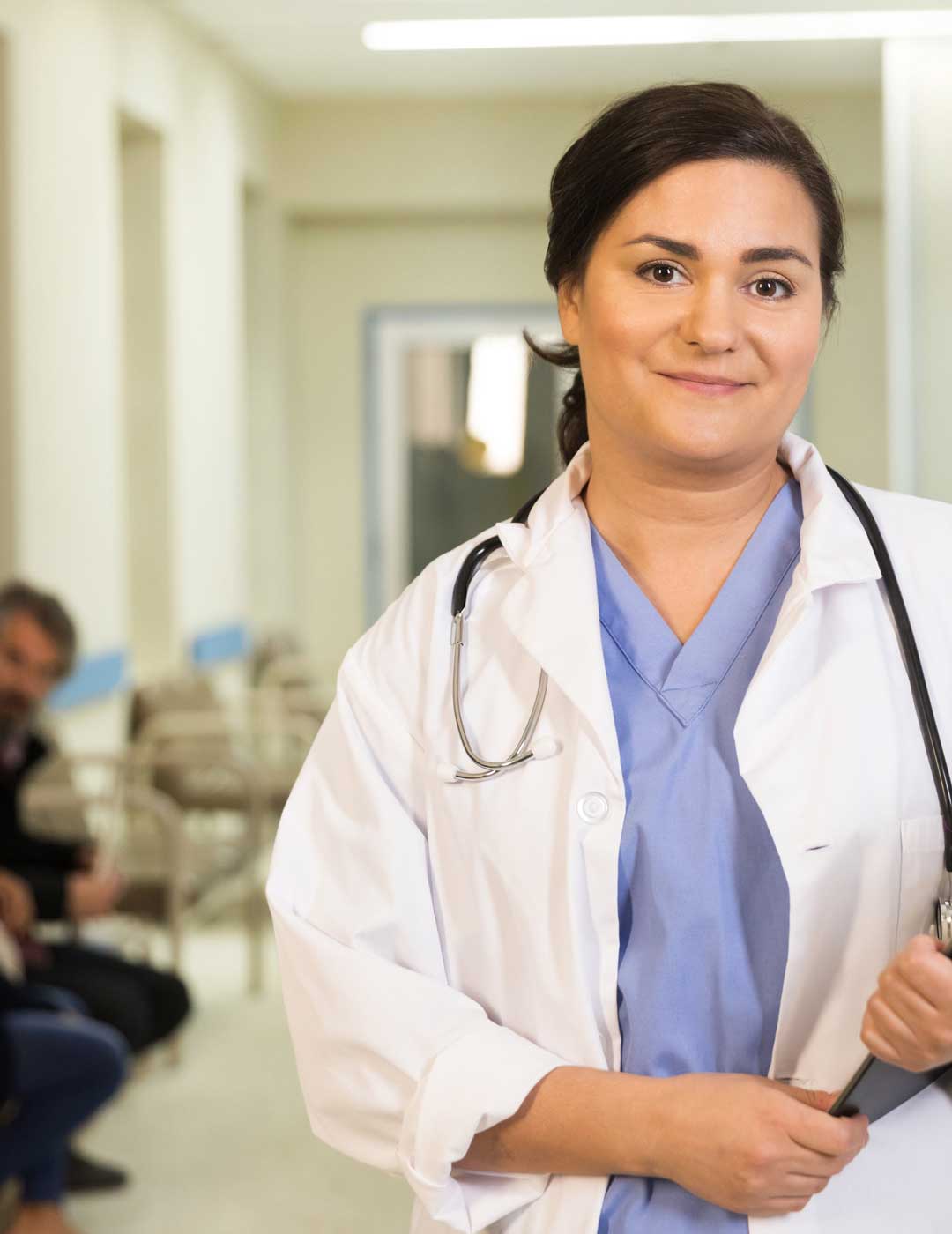 a-doctor-smiles-while-holding-her-clipboard